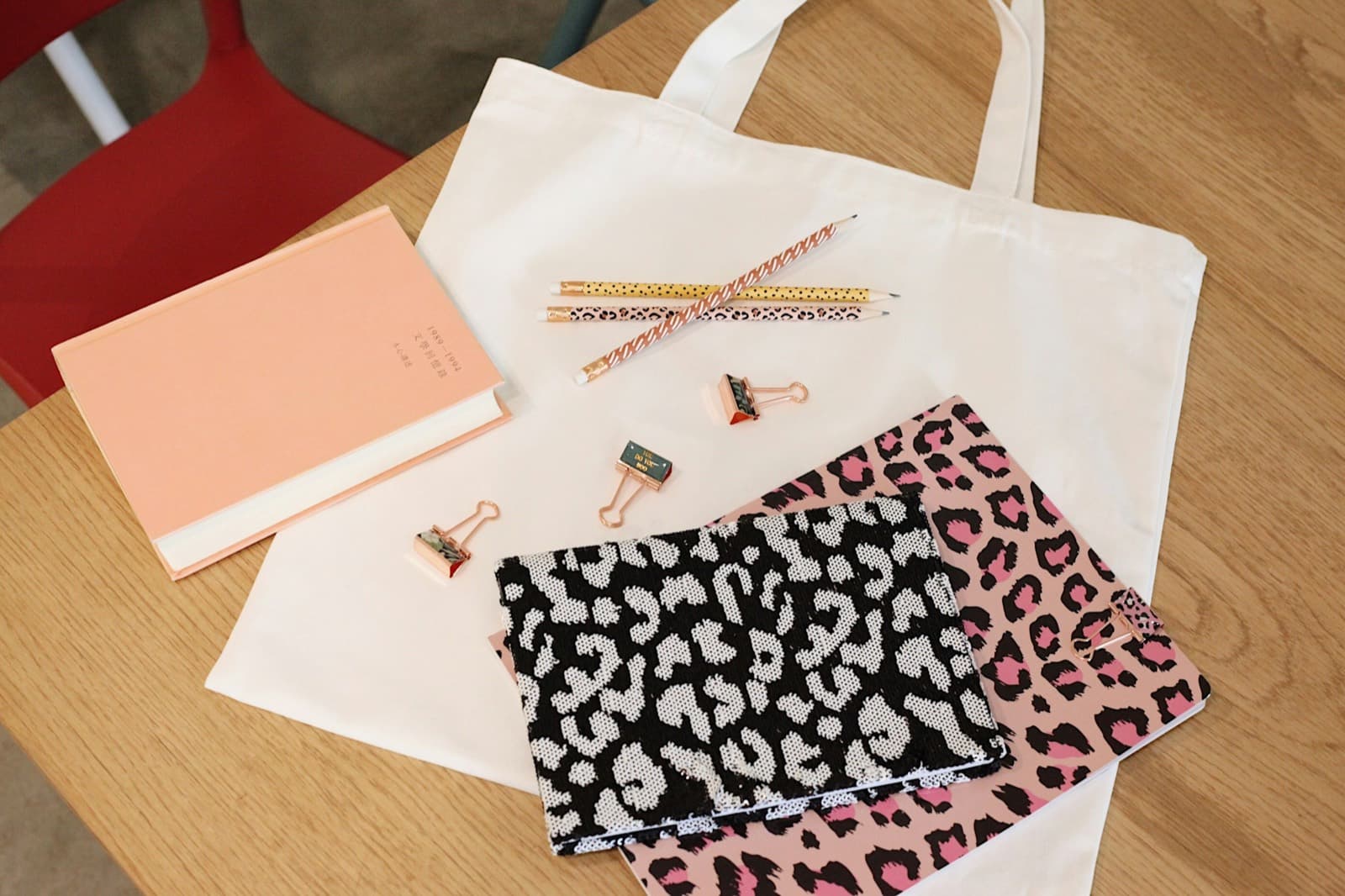 A tote bag, notebooks and pencils